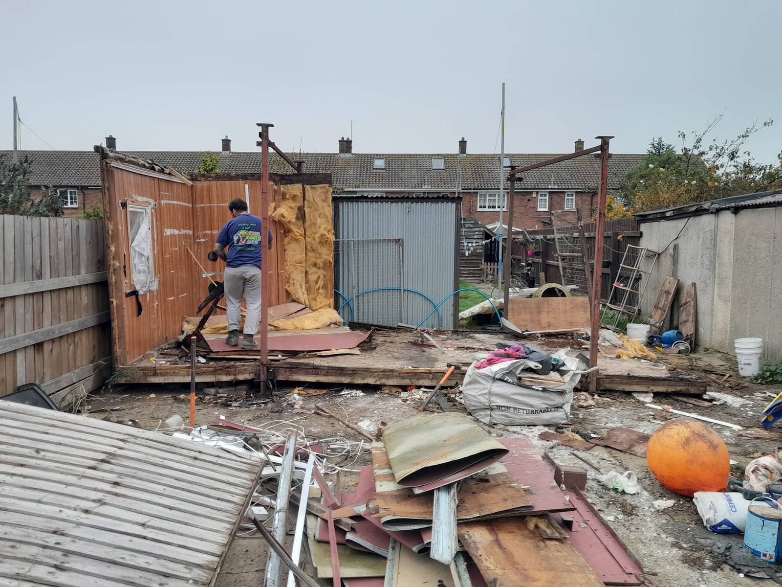Essex Waste Man at work taking apart an old shed during shed demolition