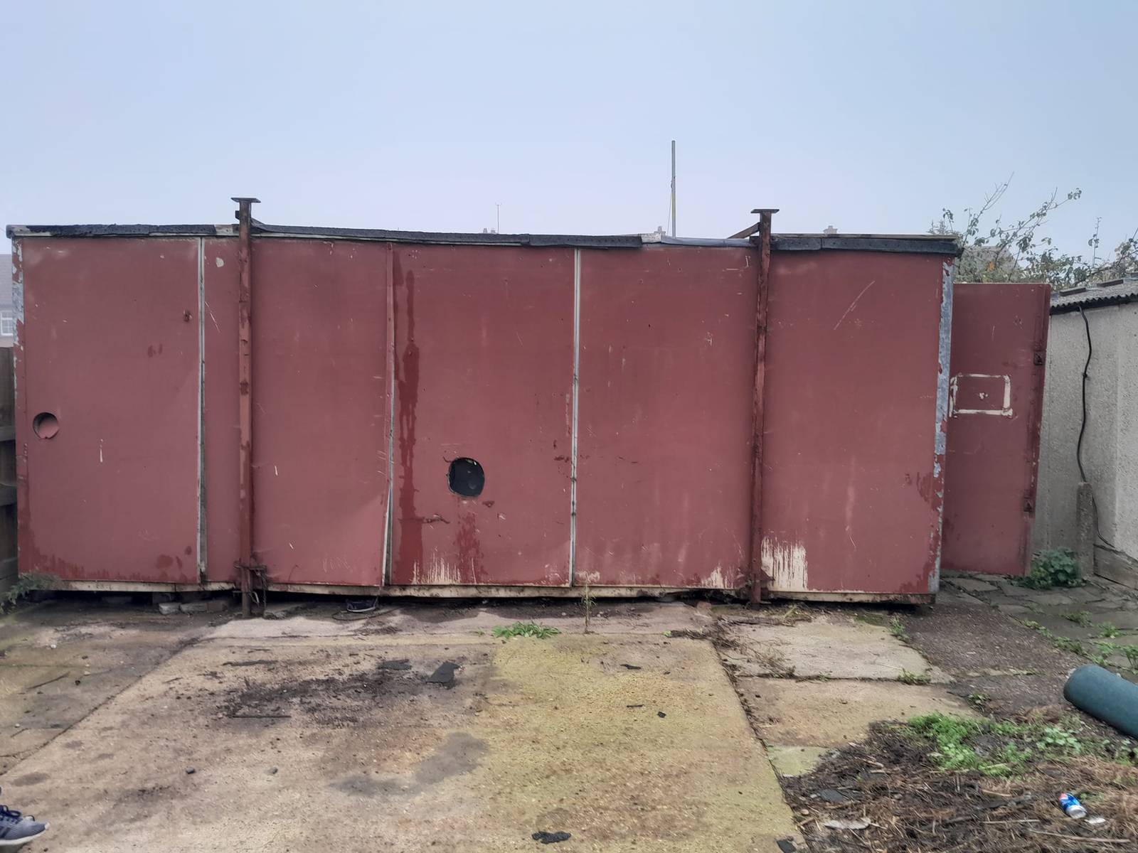 A old shed faded red in need of removing